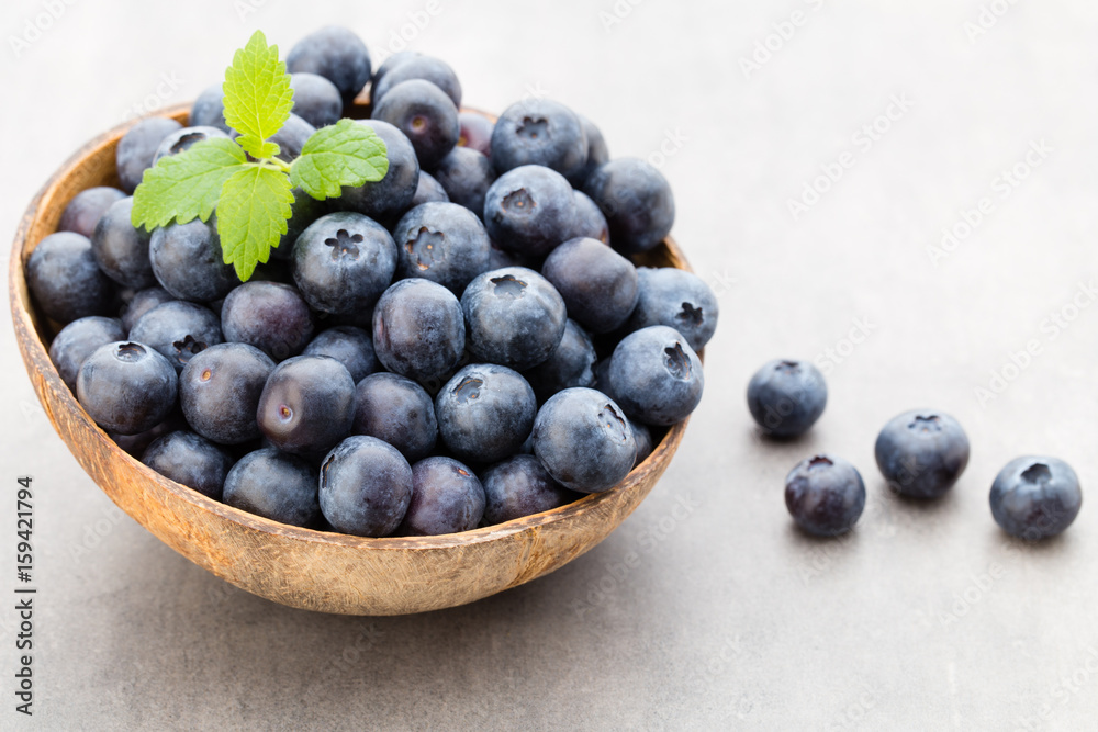 Fresh blueberries natural coconut in a bowl on a gray background. Fresh blueberries natural coconut in a bowl on a gray background.