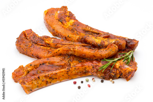 Spicy marinated spare ribs barbecued on the white background.