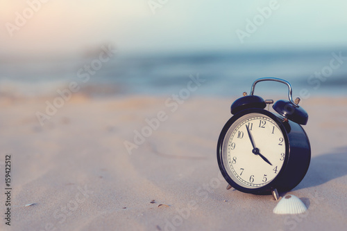 Alarm clock is located on the beach.