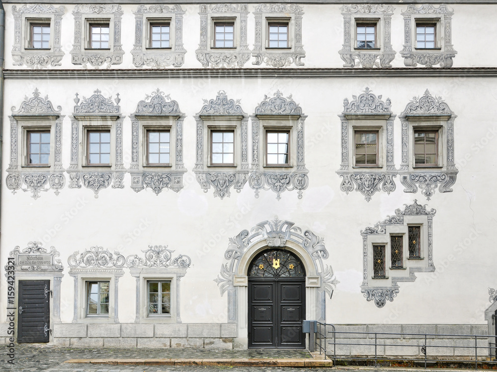 Front facade of an ancient building in Ravensburg with painted decor on the white wall. Baden-Wurttemberg, Germany.