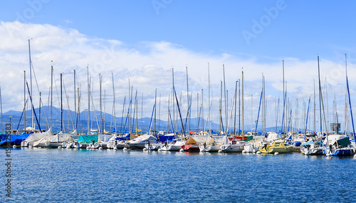 Part of yachts and boats at Ouchy port with the blue spring sky on the background. Lausanne, Switzerland