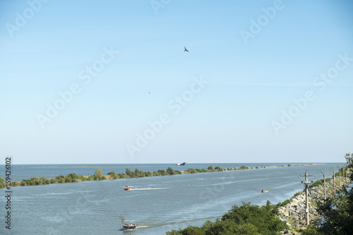 Landscape with the water channel between Danube Delta and Black Sea, Romania, in a summer sunny day photo