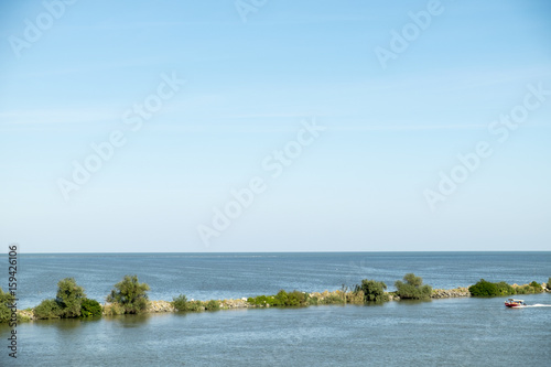 Landscape with the water channel between Danube Delta and Black Sea, Romania, in a summer sunny day photo