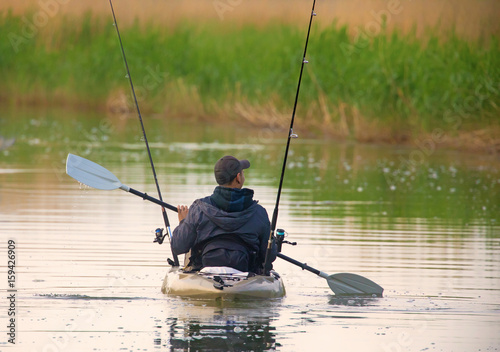 Fisherman in inflatable canoe