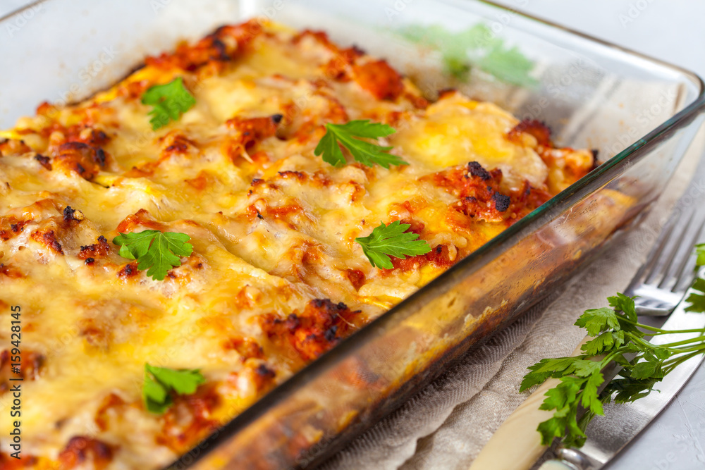 Traditional Italian meat lasagna baked in glass form.