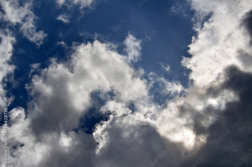 Blue sky with white and gray cumulus clouds. Closeup Blue sky with white and gray cumulus clouds. Closeup
