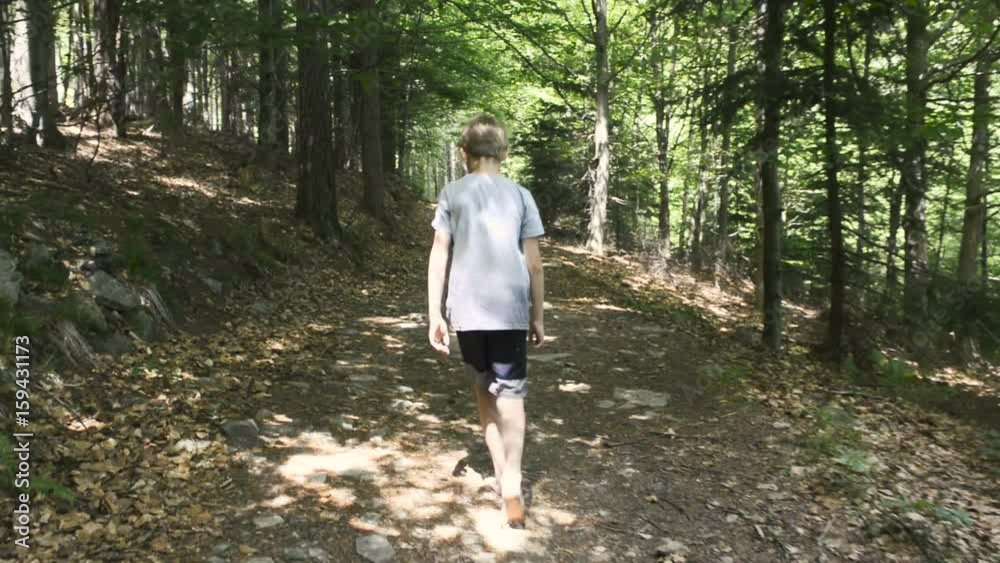 Child Boys' bare feet walking along a mountain stony path Child Boys' bare feet walking along a mountain stony path