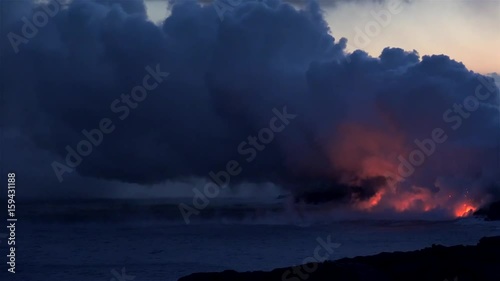 Lava flows into the ocean at night. Kilauea Volcano, Hawaii Big Island, USA.