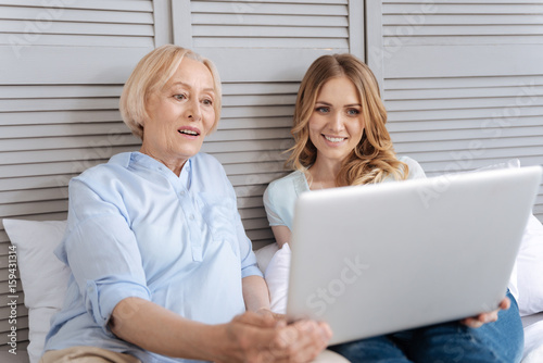 Mother and daughter immersed into watching video