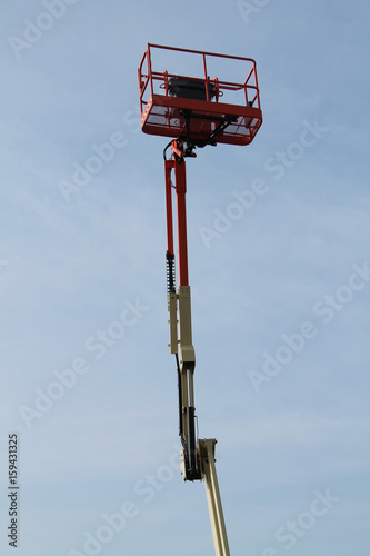 A Very High Extended Arm and Cage of a Cherry Picker.