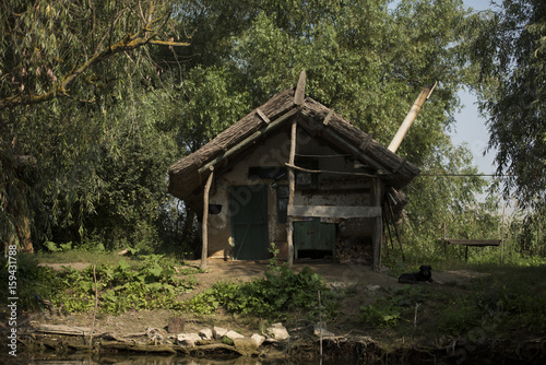 Old wooden house on a channel in Danube Delta  Romania  in a sunny summer day
