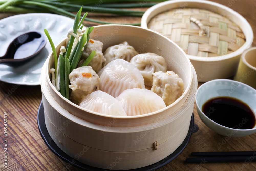 Traditional Chinese Dim Sum as close-up on Bamboo Steamer Traditional Chinese Dim Sum as close-up on Bamboo Steamer