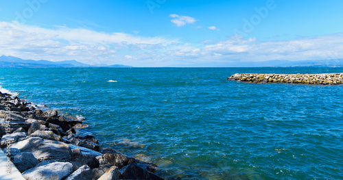 Entrance to the harbor Ouchi with the stone mole and coast