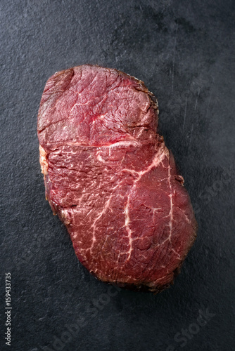 Dry aged raw Wagyu Point Steak as close-up on a slate