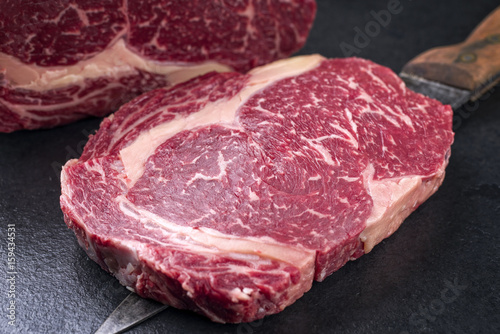 Raw dry aged Kobe Entrecote Steak as close-up on a slate
