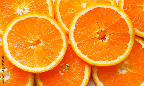 Pile of bright sliced oranges on white background