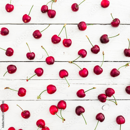 Tasty red cherry on white rustic table. Flat lay. Top view. Summer berries