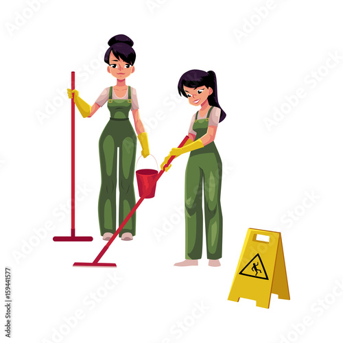Two cleaning service girls, charwomen in overalls using mops and bucket, wet floor sign, cartoon vector illustration isolated on white background. Cleaning service girls in uniforms washing floor