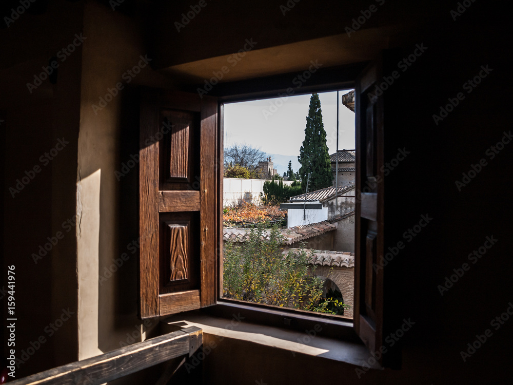 Open window of Dar-al-horra palace and Alhambra in Granada, Spain