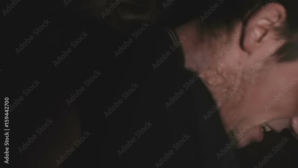 Frightened young guy tries to take off his handcuffs close up Frightened young guy tries to take off his handcuffs close up