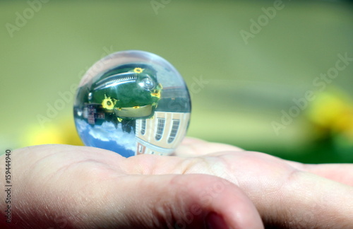 Glass ball on the hand.