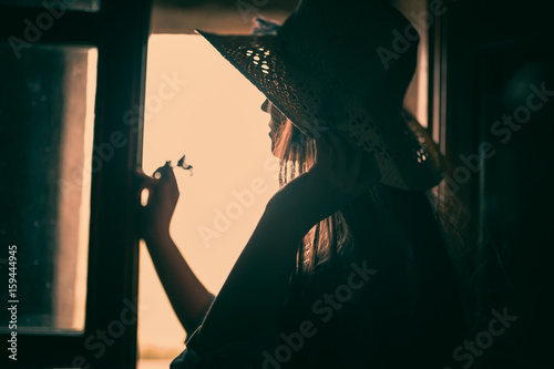 woman facing out of the window