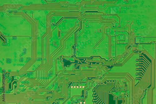 Circuit board, modern electronics backside green color background closeup