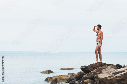 Young man enjoying the view by the sea