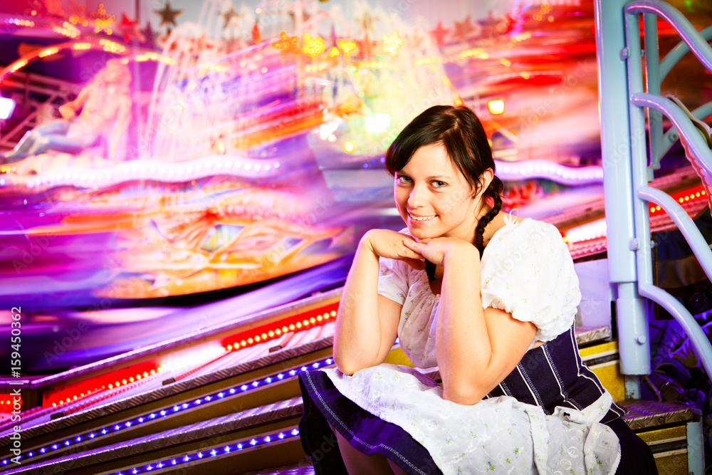 Young Woman Sitting Next To Carousel Young Woman Sitting Next To Carousel