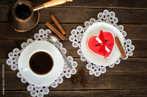 Cozy holiday. Mug coffee, heart shaped gingerbread, cezve. Top view