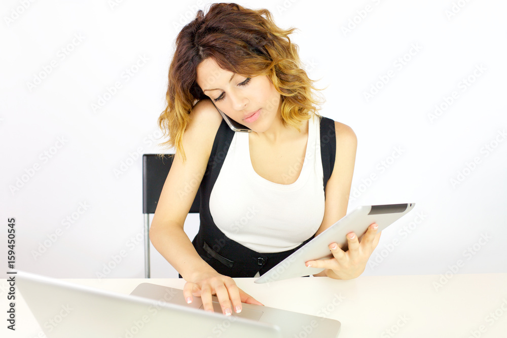 Gorgeous business woman working with tablet pc and phone in office isolated Gorgeous business woman working with tablet pc and phone in office isolated