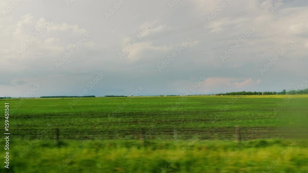 Go along the agricultural area of Hungary. View from the window of a fast traveling bus or car Go along the agricultural area of Hungary. View from the window of a fast traveling bus or car