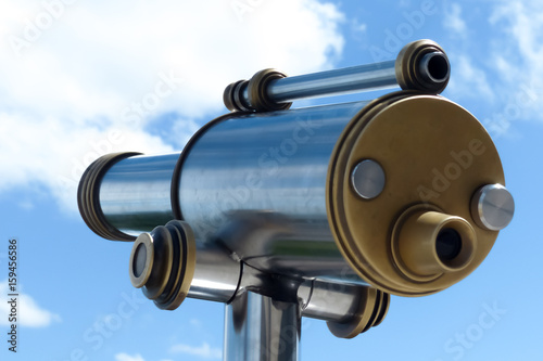 telescope isolated with blue sky and clouds on the back
