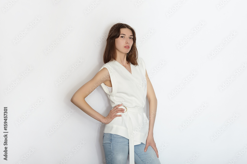 Young beautiful brunette beginner model woman practicing posing showing emotions on white wall studio background Young beautiful brunette beginner model woman practicing posing showing emotions on white wall studio background