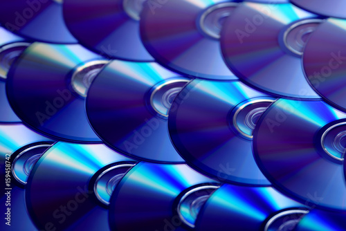 Compact discs background. Several cd dvd blu-ray discs. Optical recordable or rewritable digital data storage.