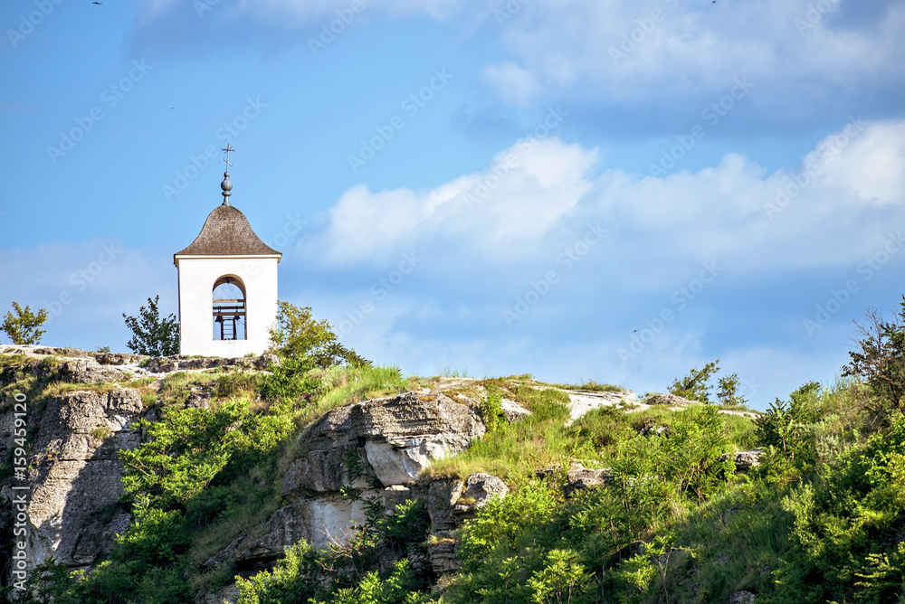 Wonderful landscape with rocks and mountains at orheiul vechi monastery and memorial in moldova, near raut river, blue sky, sunny day, bell tower