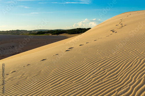 Footprints on a white sand dunes desert