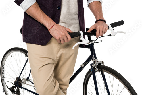 Cropped shot of stylish young man standing with bicycle isolated on white