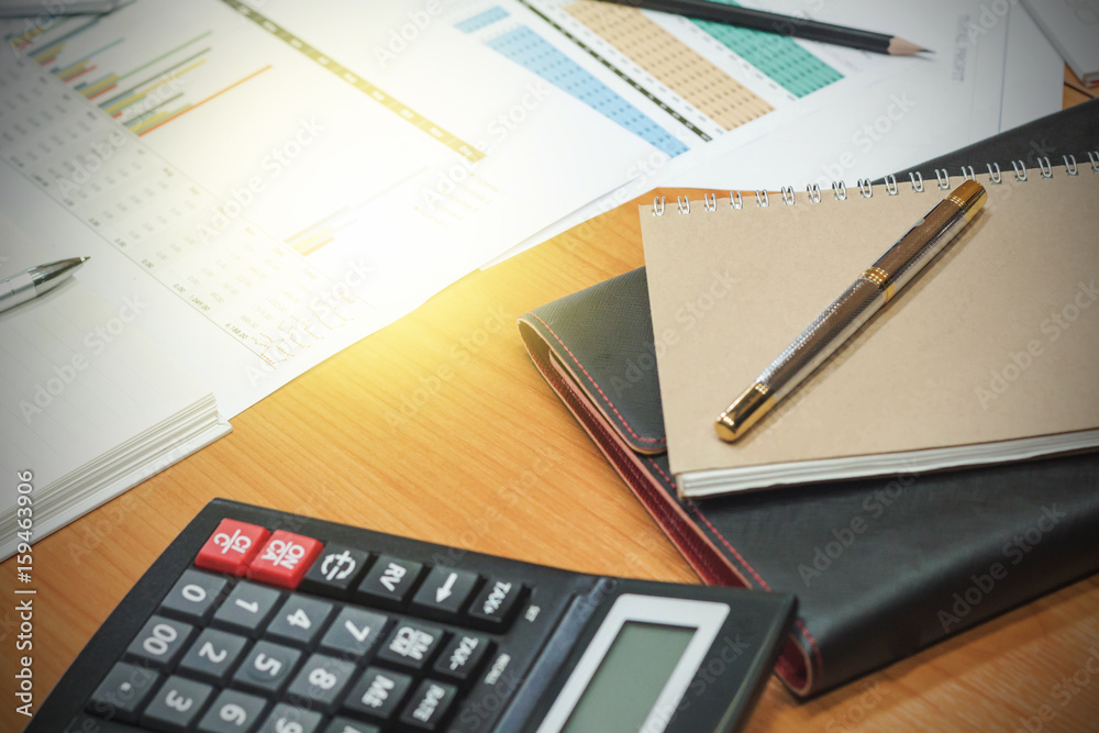 Documents and calculators on a business desk Documents and calculators on a business desk
