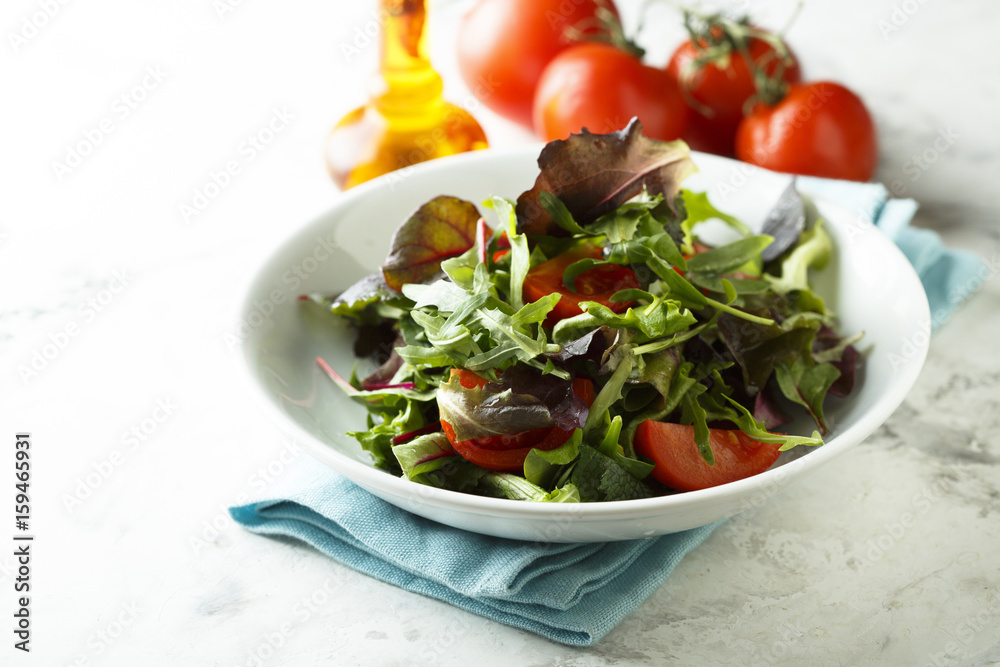 Mixed salad in a white bowl