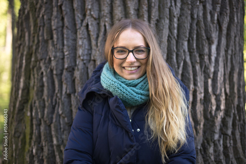 Happy girl standing by the big tree photo