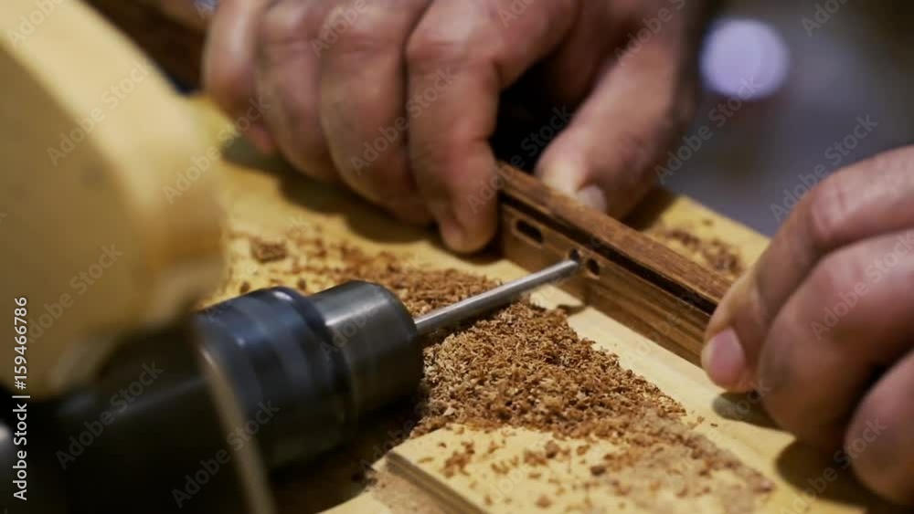 Woodwork - carpenter working with plane and wood plank at workshop. Industrial carpenter worker operating machine during wooden furniture manufacturing. Art woodworking process. Azerbaijan art. Woodwork - carpenter working with plane and wood plank at workshop. Industrial carpenter worker operating machine during wooden furniture manufacturing. Art woodworking process. Azerbaijan art.