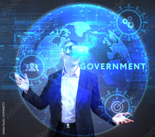 The concept of business, technology, the Internet and the network. A young entrepreneur working on a virtual screen of the future and sees the inscription: Government