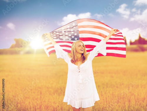 happy woman with american flag on cereal field photo