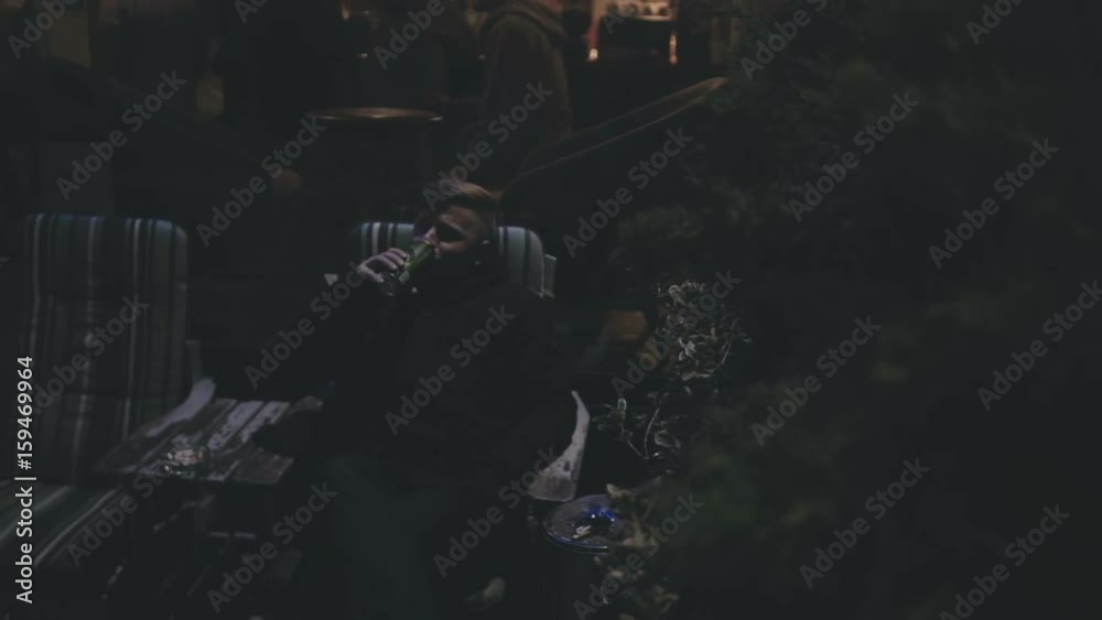 The man is drinking beer in the bar, slowmotion The man is drinking beer in the bar, slowmotion