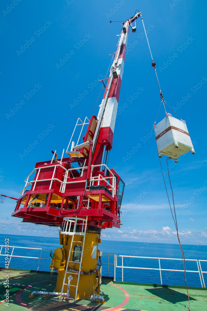 Pedestal crane, crane operator during operate crane with blue sky Stock