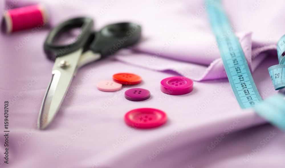 scissors, sewing buttons, tape measure and cloth scissors, sewing buttons, tape measure and cloth