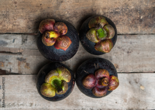 Top view of mangosteen fruit isolated on the wooden table background