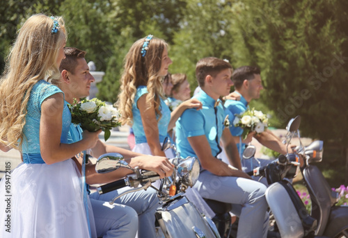 Bridesmaids and best men with scooters