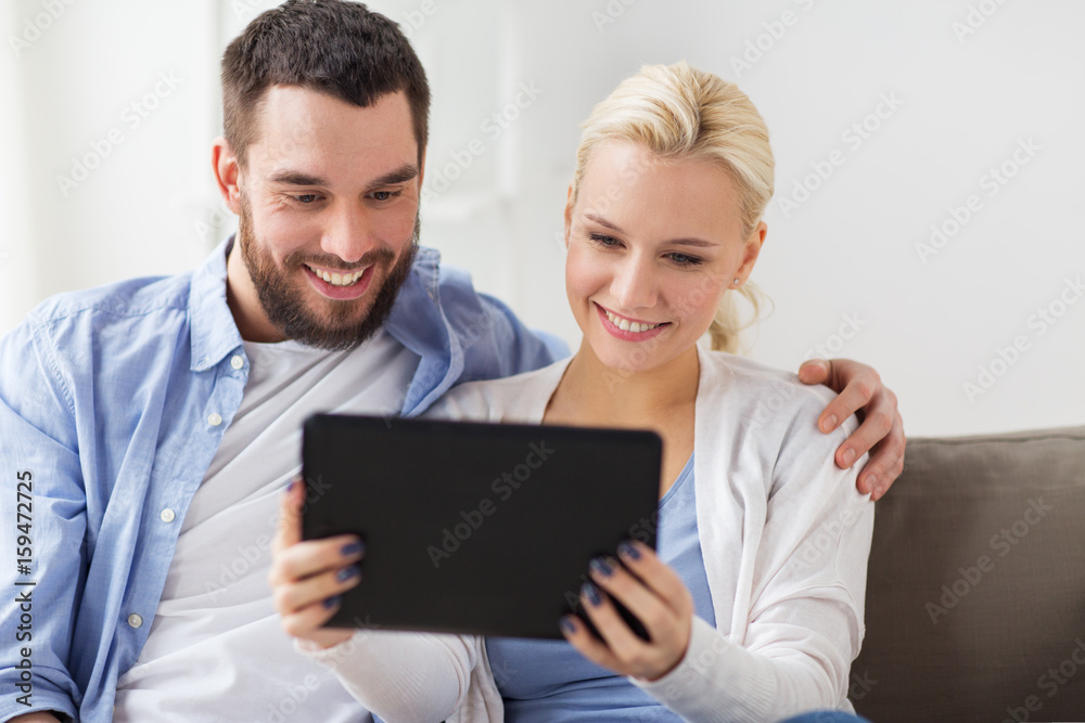 smiling happy couple with tablet pc at home smiling happy couple with tablet pc at home